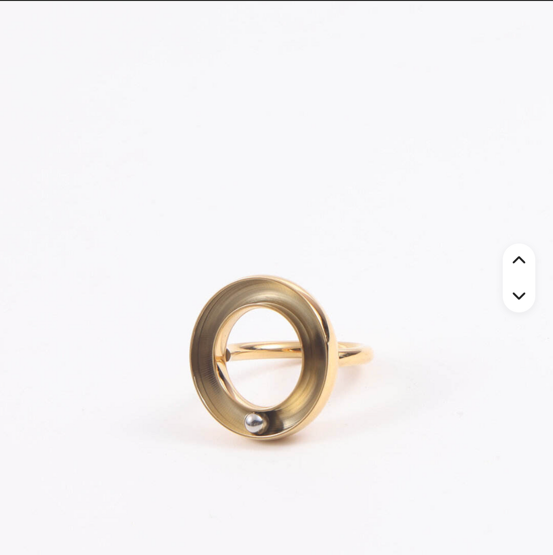 Galenée Orbit Ring — gold halo ring with rolling steel bead, studio shot